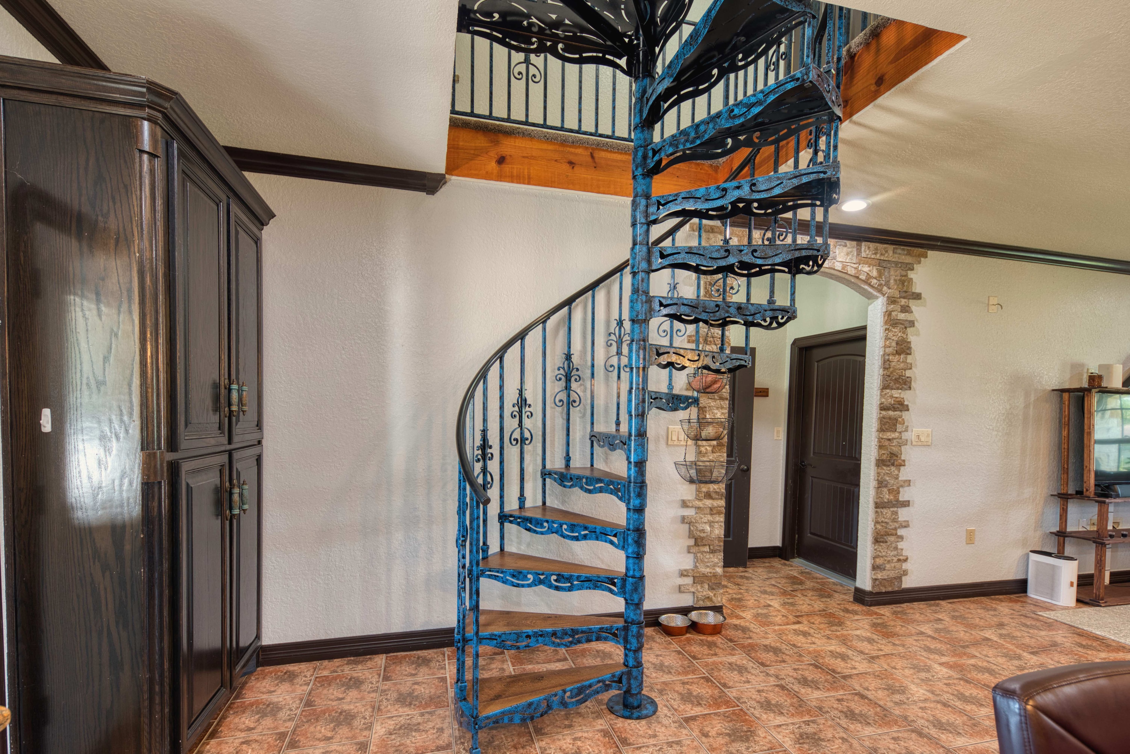 Blue ornate spiral staircase with wood accents